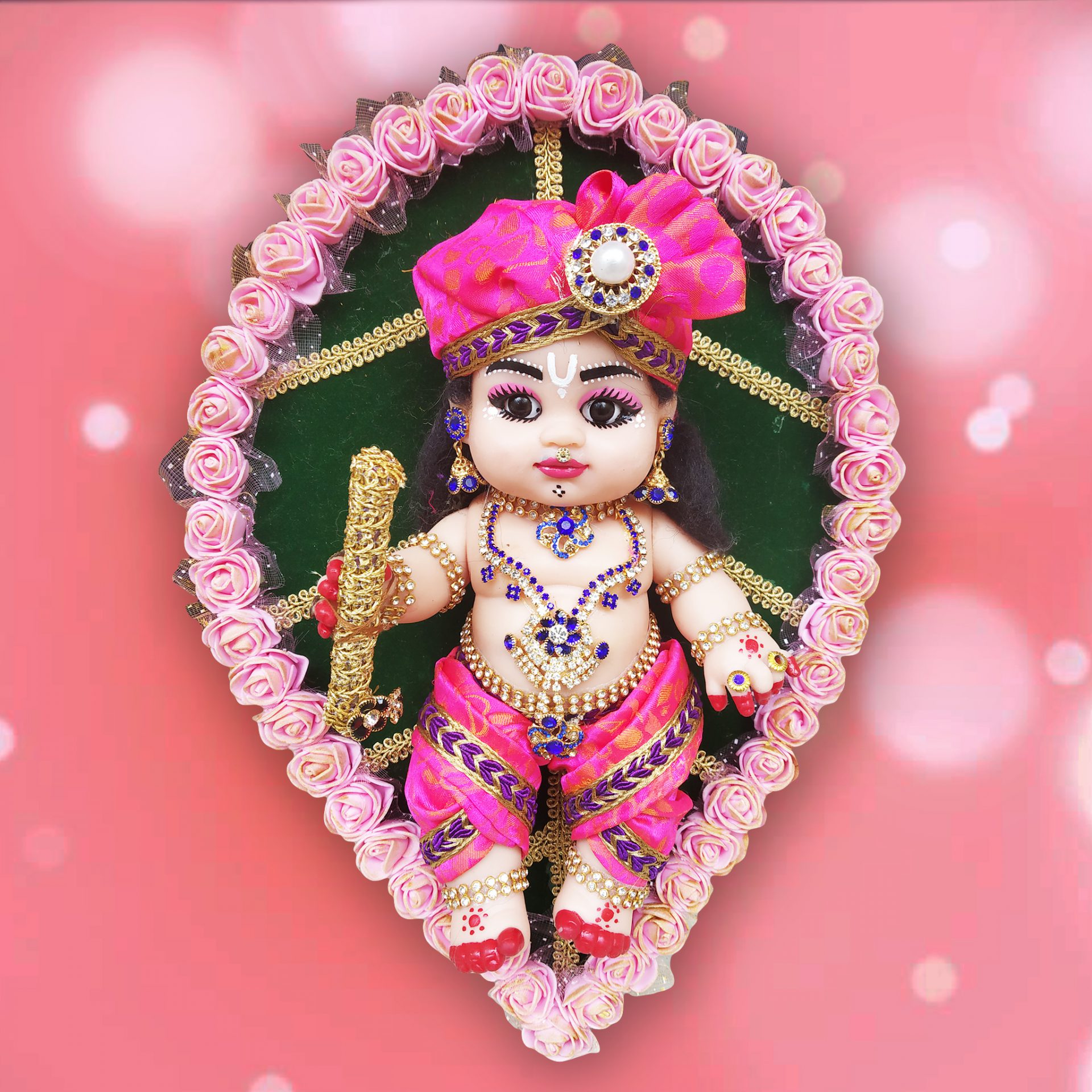 Baby Krishna sitting on a leaf doll Trogons